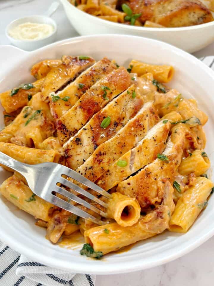 plated pasta with chicken and garnish on top