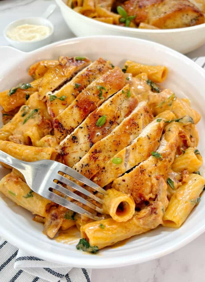 plated pasta with chicken and garnish on top