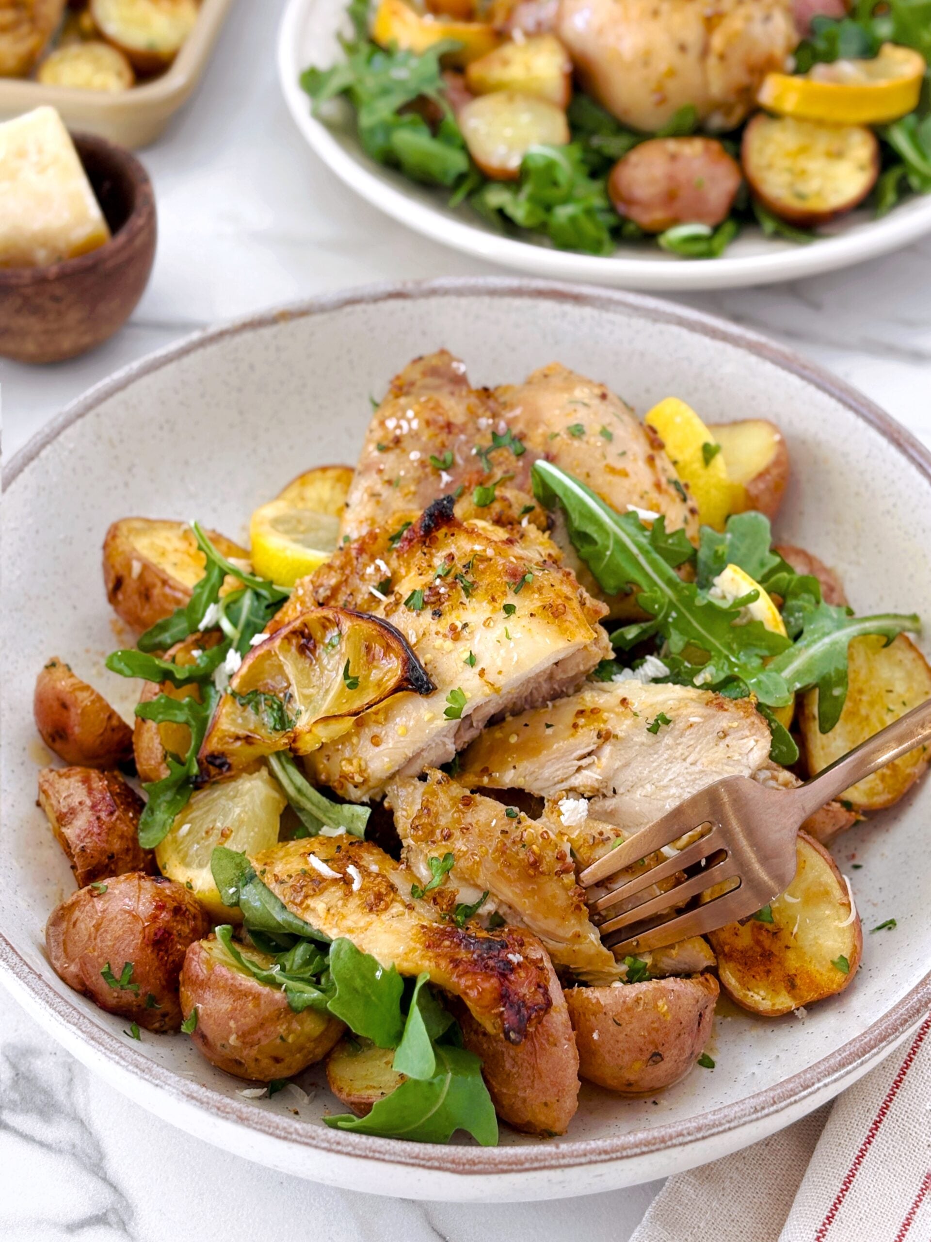 lemon chicken with potatoes on a plate 