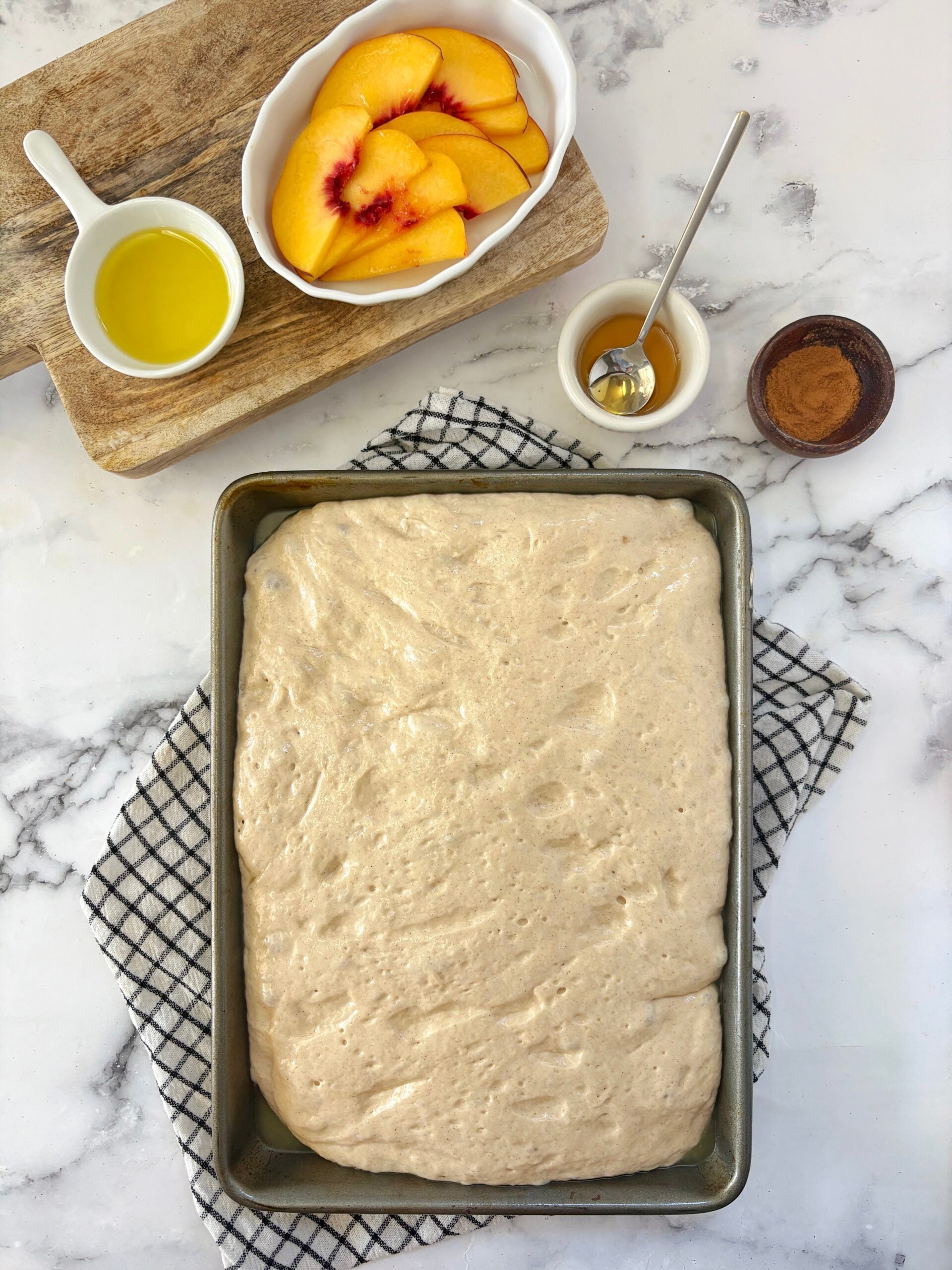 dough with peaches on side